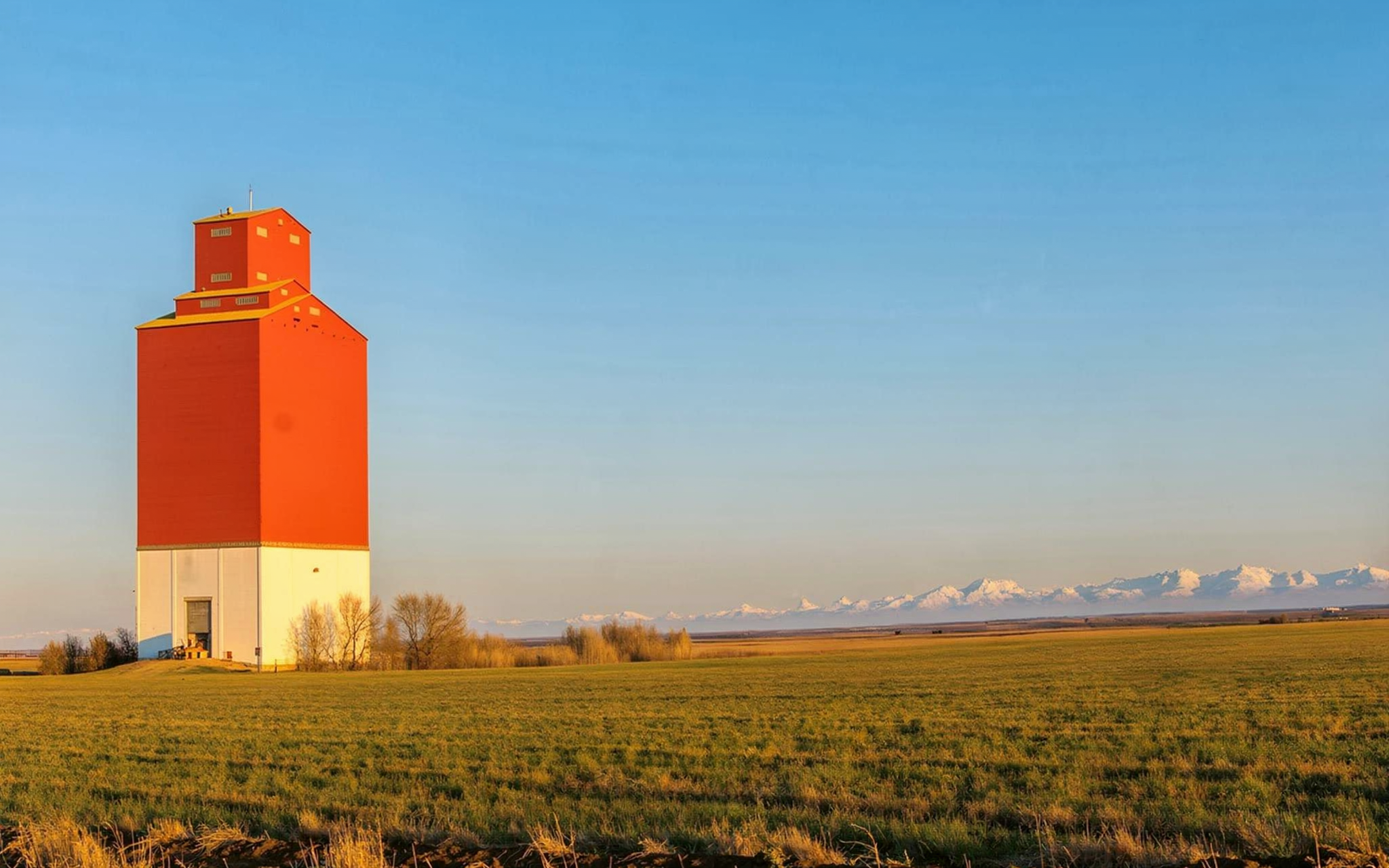 Golden-hour prairie and grain elevator near Olds, Alberta